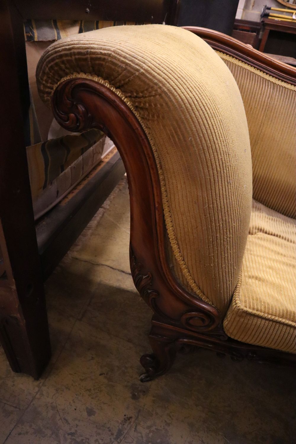 An early Victorian rosewood scroll end settee, width 220cm, depth 64cm, height 88cm